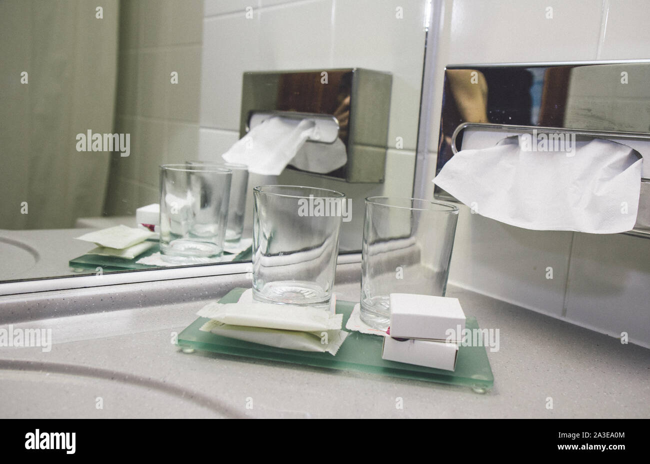 Water tap bath in modern hotel luxury leisure service. Hotel room service dental wash glass and soap hygienic person cleaning washing. Paper towels sh Stock Photo