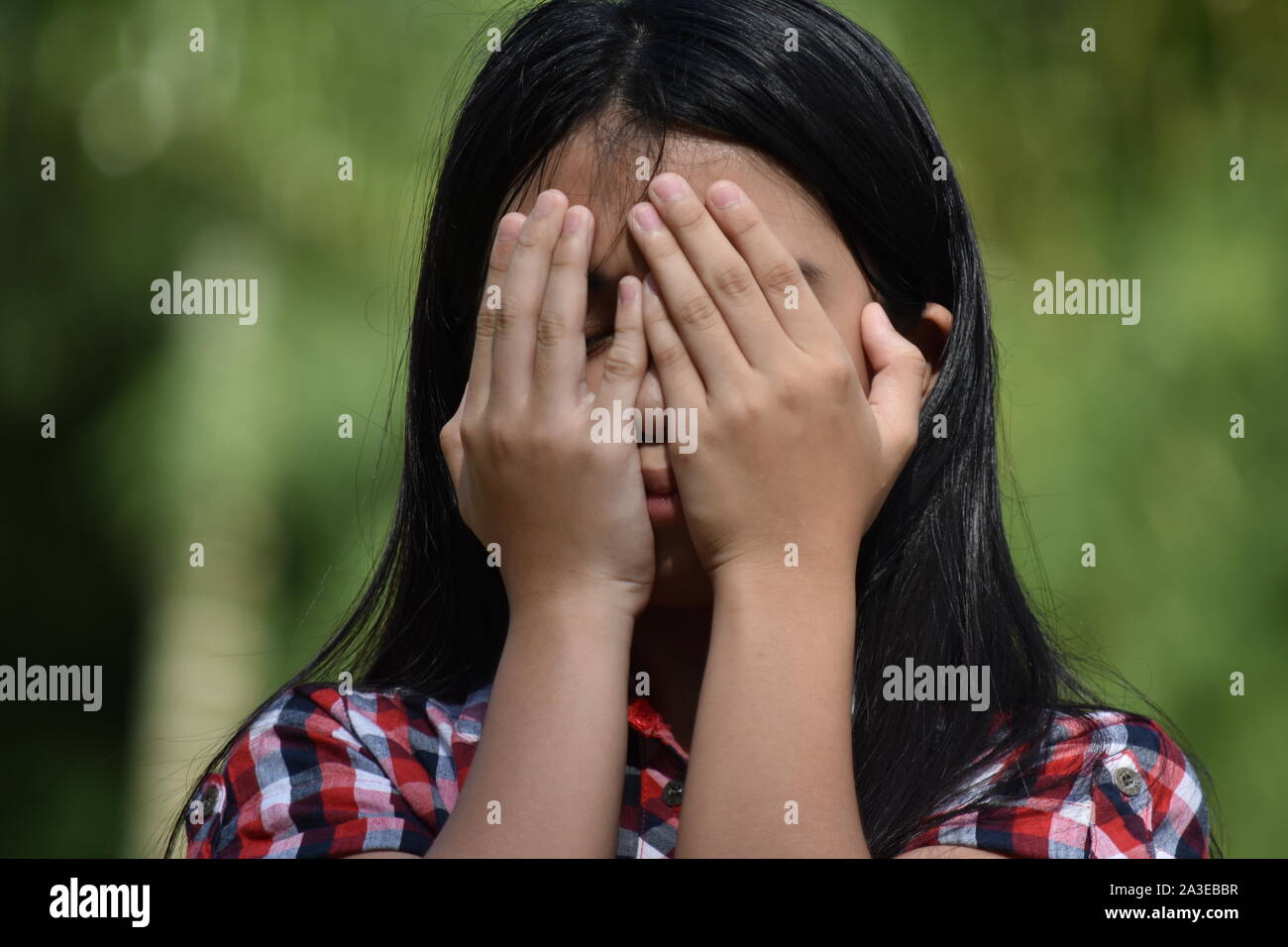 An Ashamed Petite Diverse Person Stock Photo