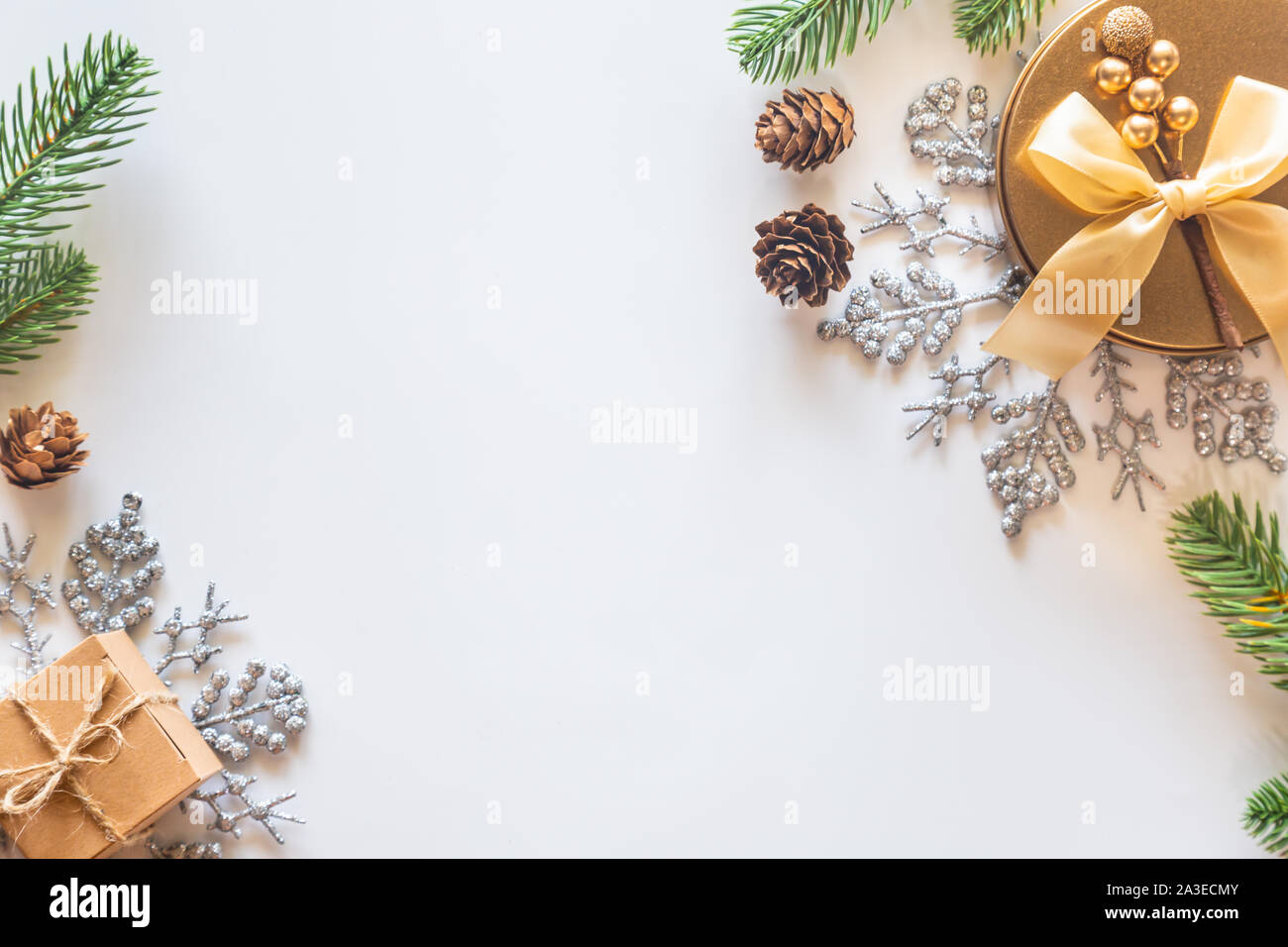 Holiday Christmas card background with festive decoration ball, stars, snowflakes, gift box, pine cones on a white background from Flat lay, top view. Stock Photo