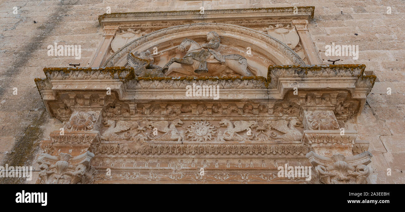 Melpignano. Greek city, view of the frieze on the doorway of the cathedral that represents St. George killing the dragon. Stock Photo