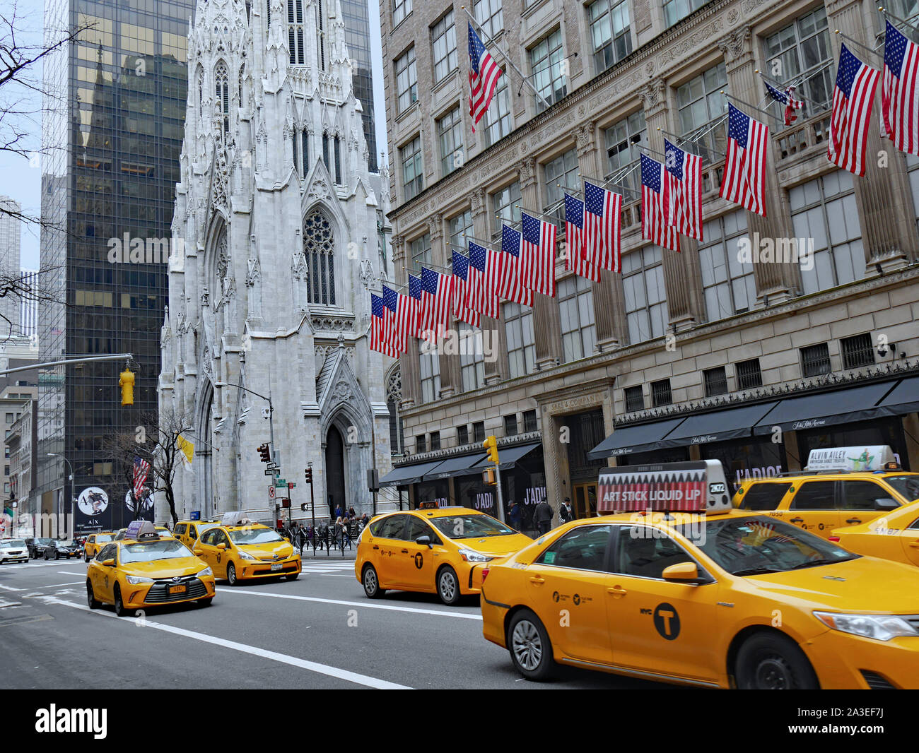 NEW YORK CITY - MARCH 2017:  The huge main store of fashion chain Saks Fifth Avenue is located next to St. Patrick's Cathedral. Stock Photo