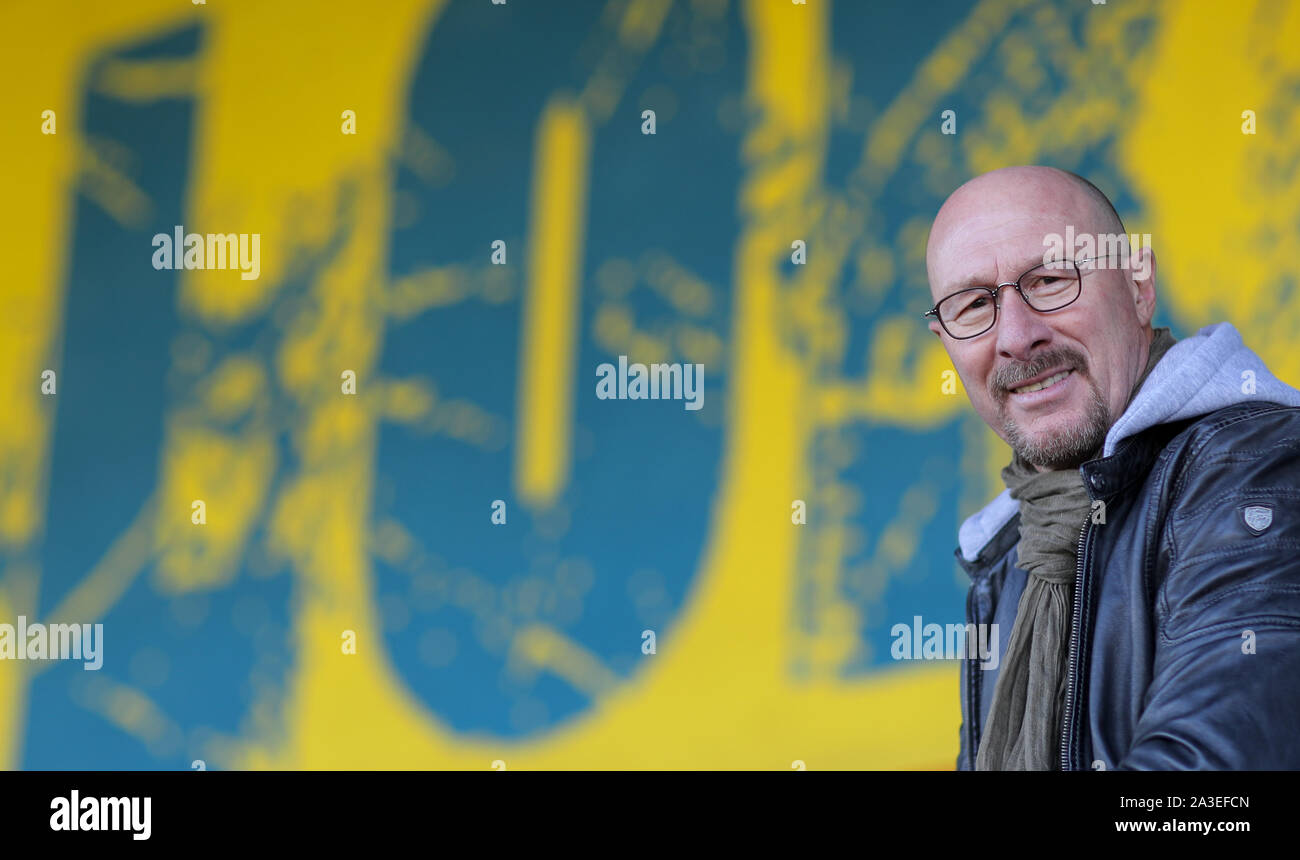 Leipzig, Germany. 07th Oct, 2019. Wolfgang Wolf, sports director at the regional league team Lok Leipzig, sits on the historic grandstand in the Bruno-Plache Stadium. The Palatine is to lead the traditional club with its experience and know-how back into paid football. (to dpa 'Back to professional football - Wolf and his visions with Lok Leipzig') Credit: Jan Woitas/dpa-Zentralbild/dpa/Alamy Live News Stock Photo