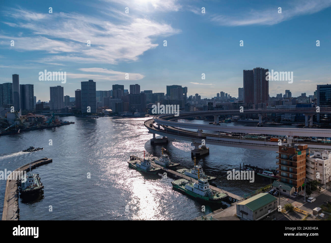 View of the Tokyo Bay during the day from the Rainbow Bridge in Odaiba. Busy waterway with ships. Landscape Orientation. Stock Photo