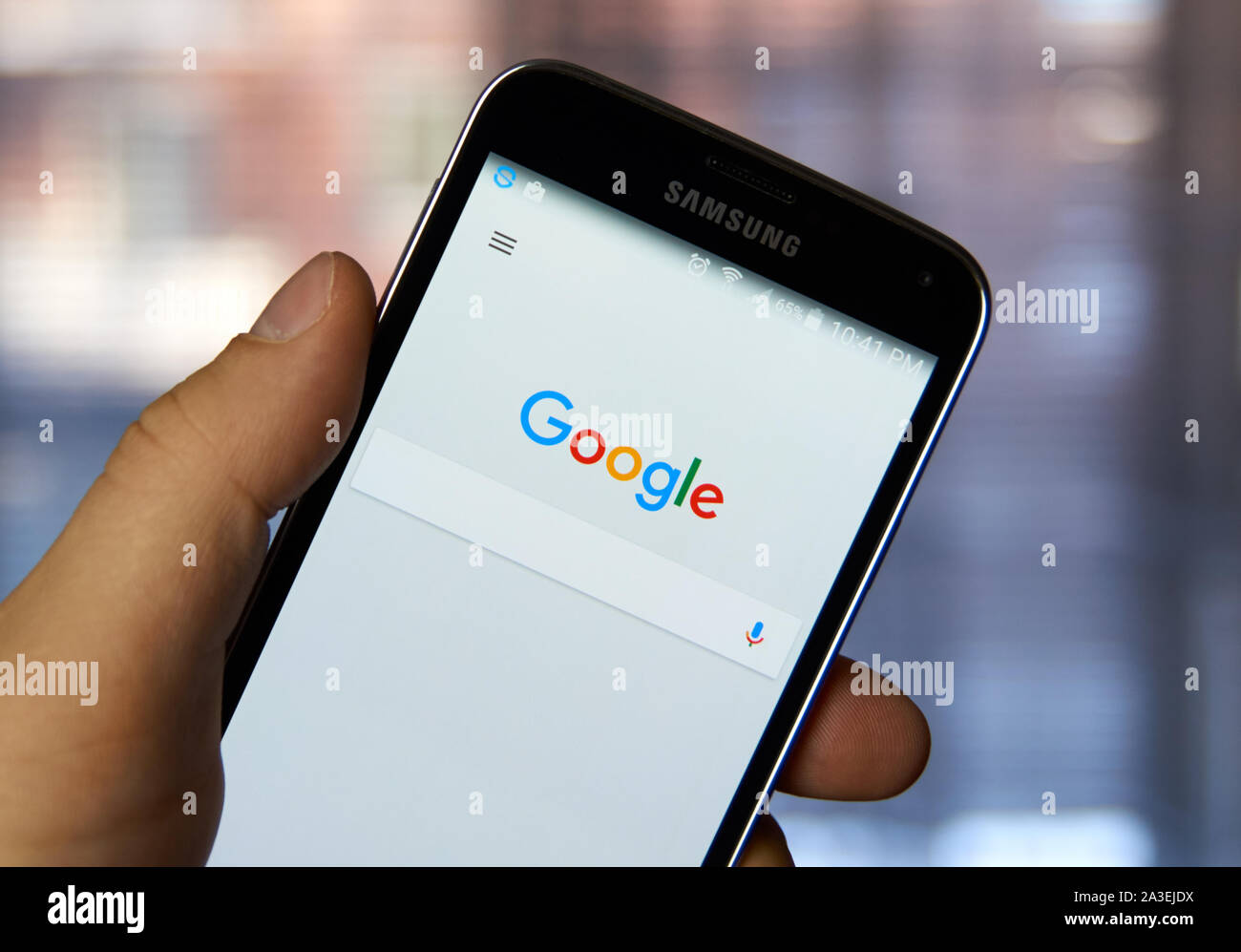 MONTREAL, CANADA - MARCH 4, 2016 - Google mobile application on Samsung device's screen in a hand. Google is well known for it's web search engine. Stock Photo
