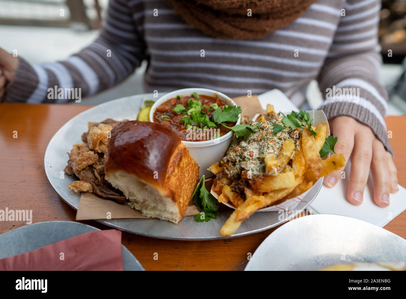 Barbeque BBQ meal with beans, brisket, bread, and French fries full plate Stock Photo