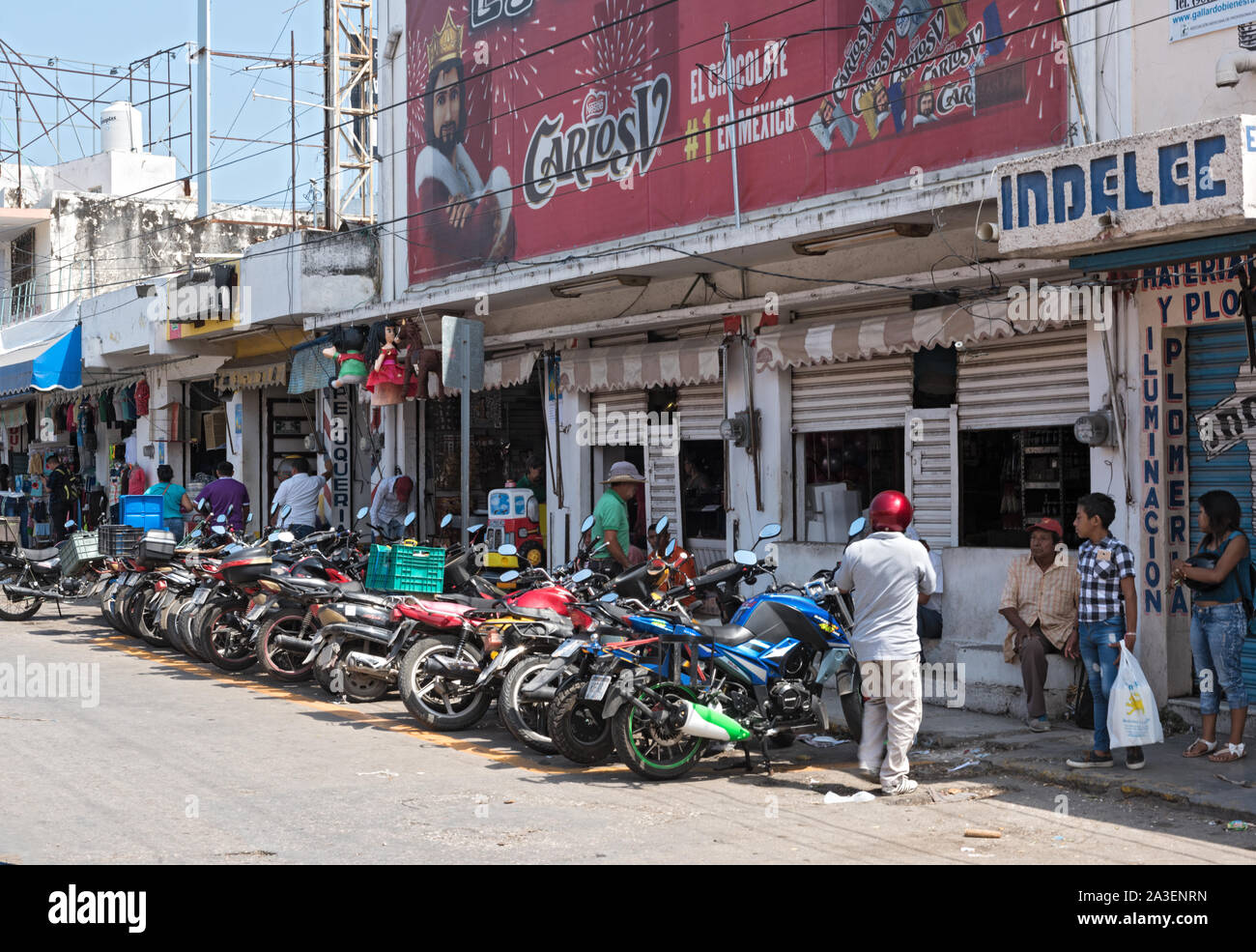 parked motorcycles on the roadside in front of the covered market in campeche mexico Stock Photo