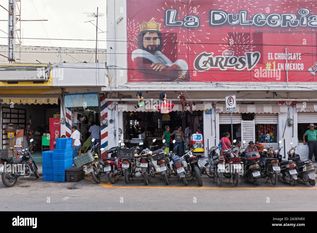parked motorcycles on the roadside in front of the covered market in campeche mexico Stock Photo