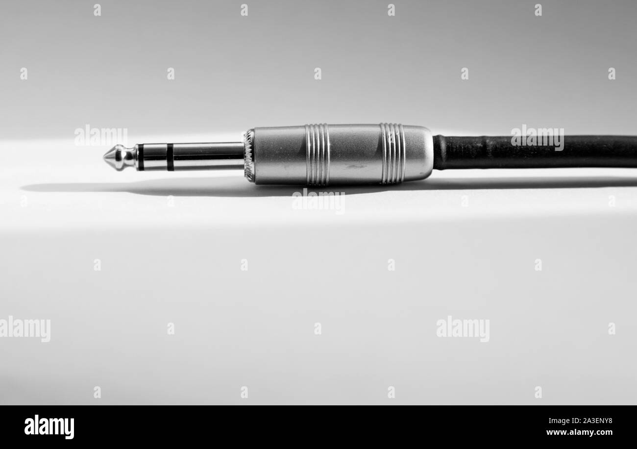 audio cord to electric guitar lies on white backgrund with sunlight Stock Photo Alamy