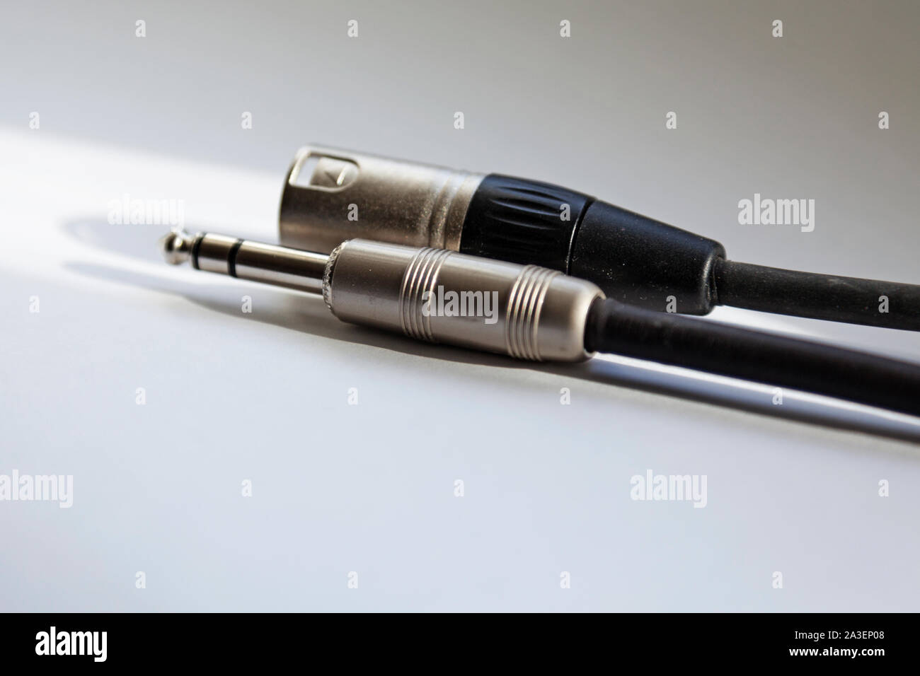 two audio cords for electric guitar lie on light background Stock Photo