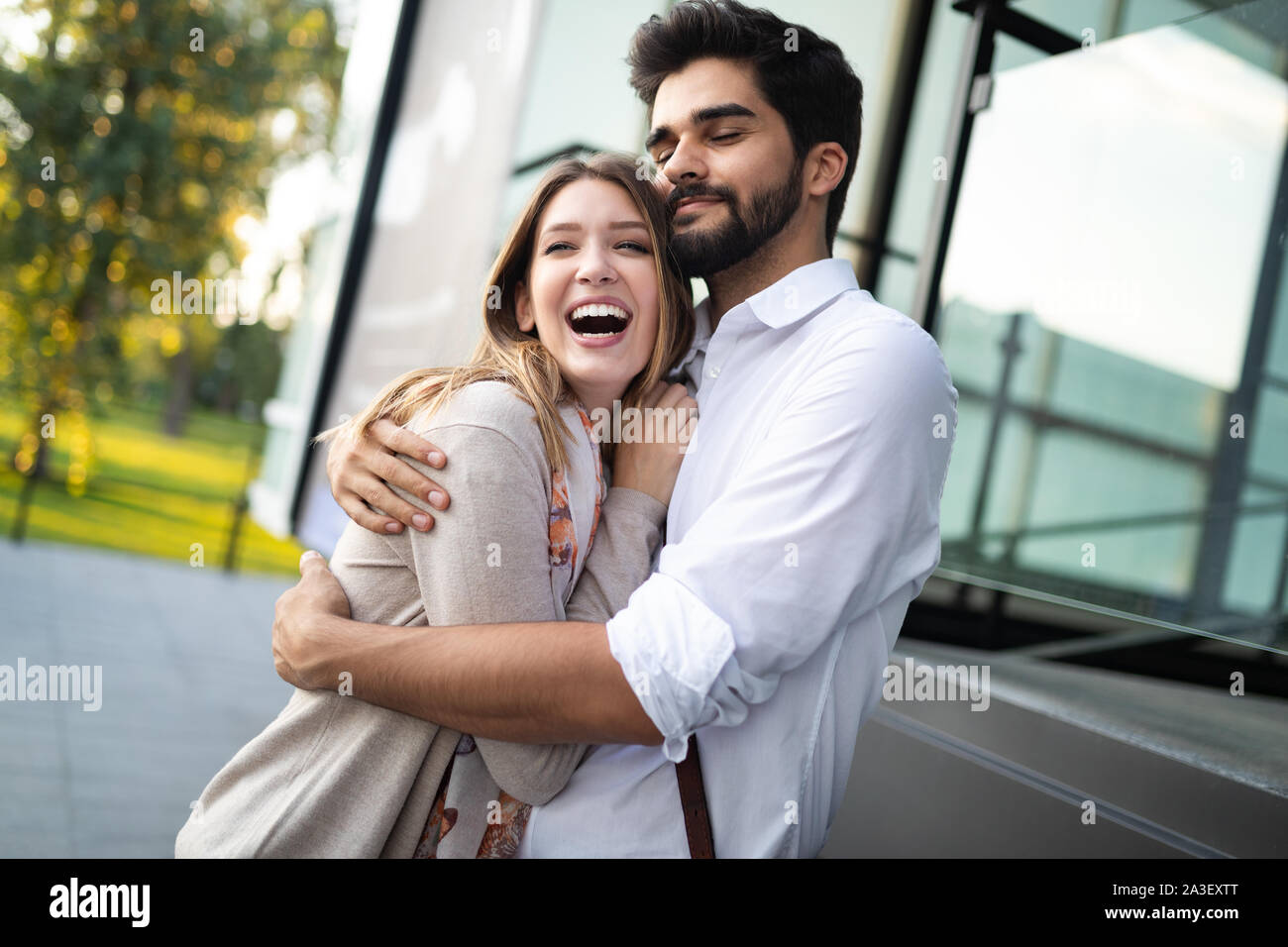 Young couple in love hug each other outside Stock Photo - Alamy