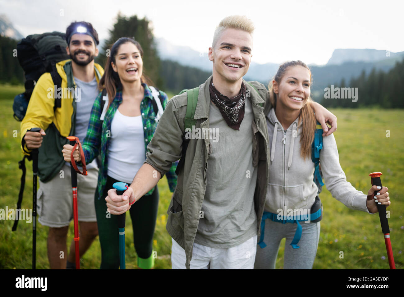 Young friends on a country walk. Group of people hiking through ...