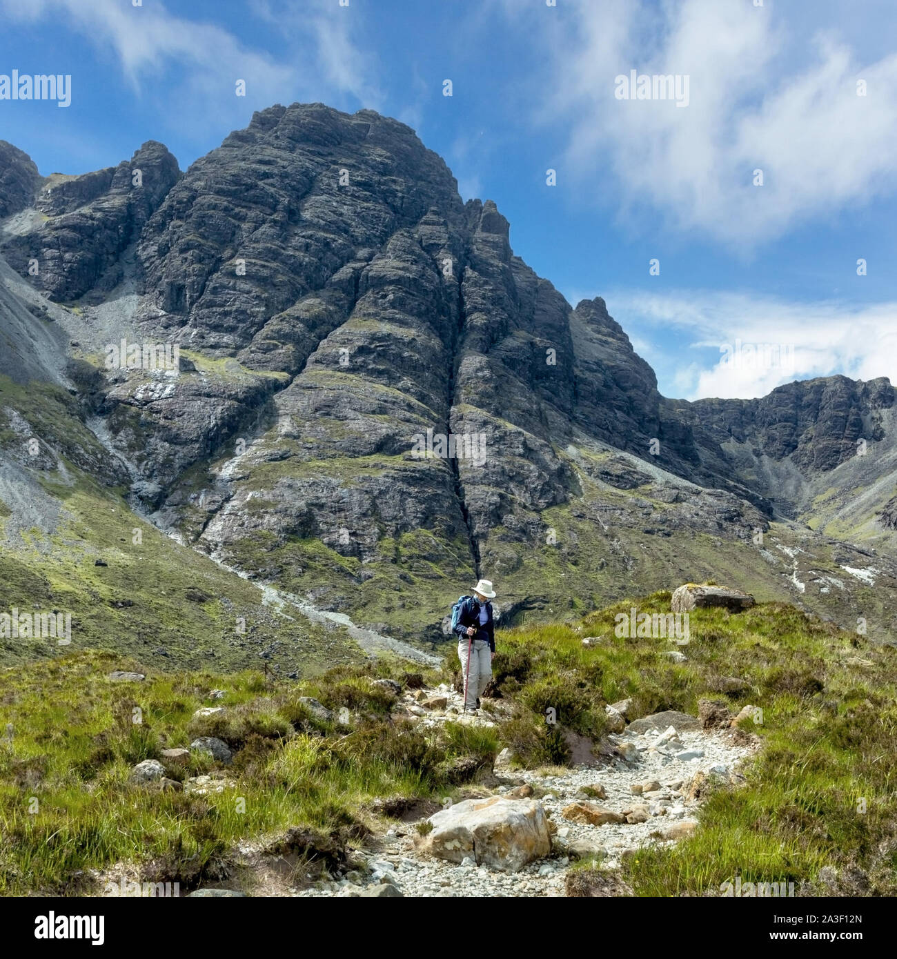 Hillwalker on the path descending from Blaven range in the Black Cuillin mountains on the Isle of Skye, Scotland, UK Stock Photo