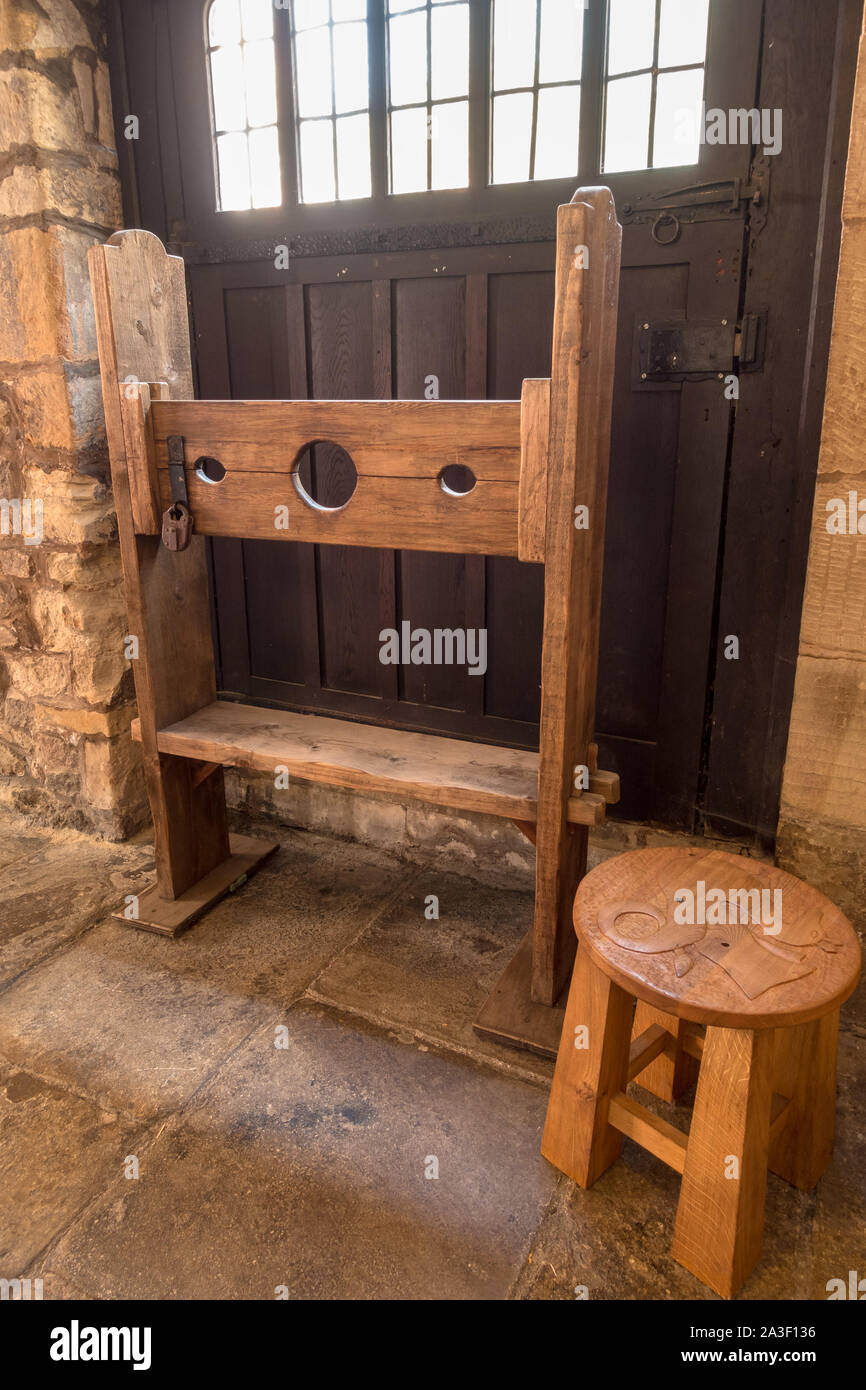 Old wooden pillory stocks on display in the Gaol of Leicester Guildhall, England, UK Stock Photo