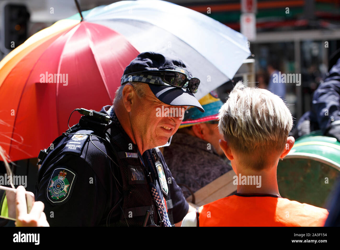 A Queensland Police officer speaks with an Extinction Rebellion representative on George Street during the protest.Climate change activism group Extinction Rebellion have amassed members in around seventy countries, and during their 'Rebellion Week' they planned to cause continued disruption to business and roads as a means to force government policy change when it comes to environmental and climate change issues. On this second day of the Rebellion Week, numerous individuals sought to cause disruptions in the Brisbane Central Business District. Stock Photo