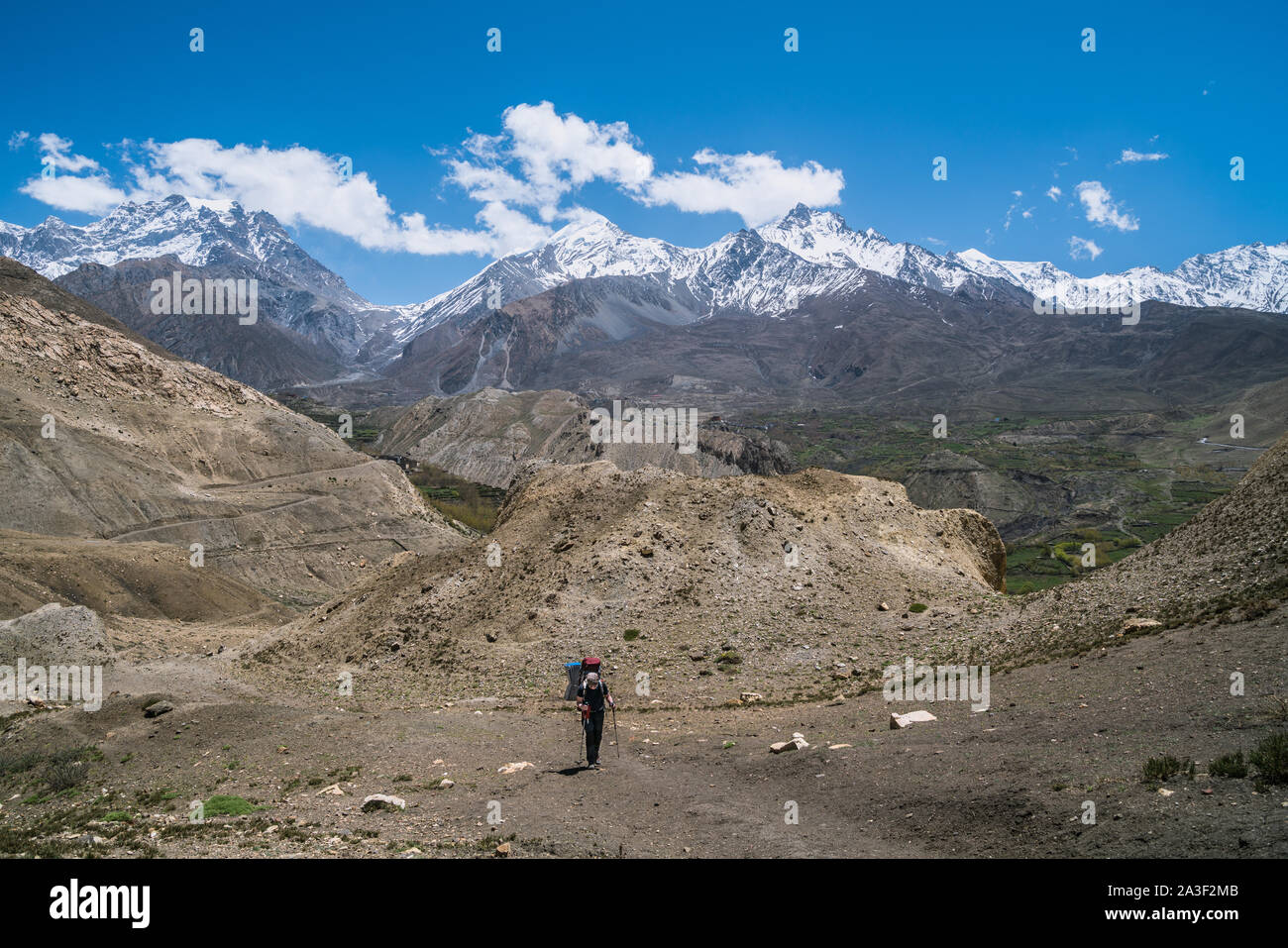 Trekkers on the way from Muktinath to Kagbeni in Mustang district, Nepal Stock Photo