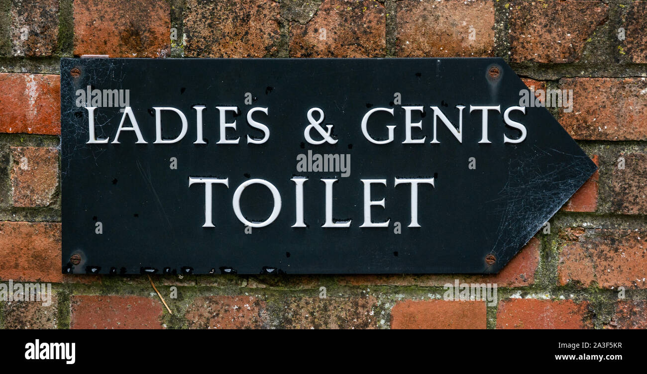 Old ladies and gents toilet sign Stock Photo