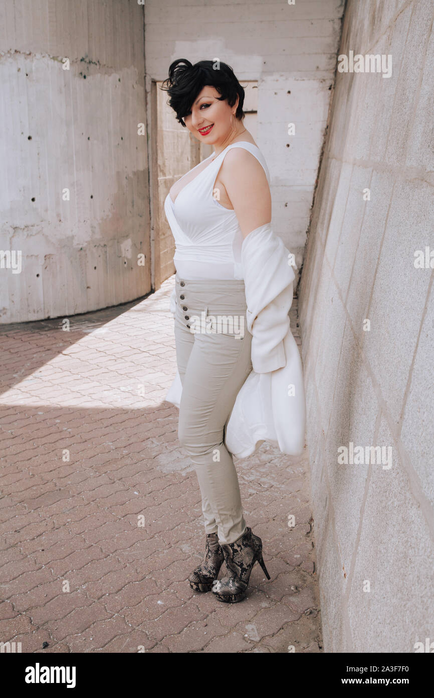 Young chubby teenage girl wear on red dress and jeans jacket posed against  school backyard Stock Photo - Alamy