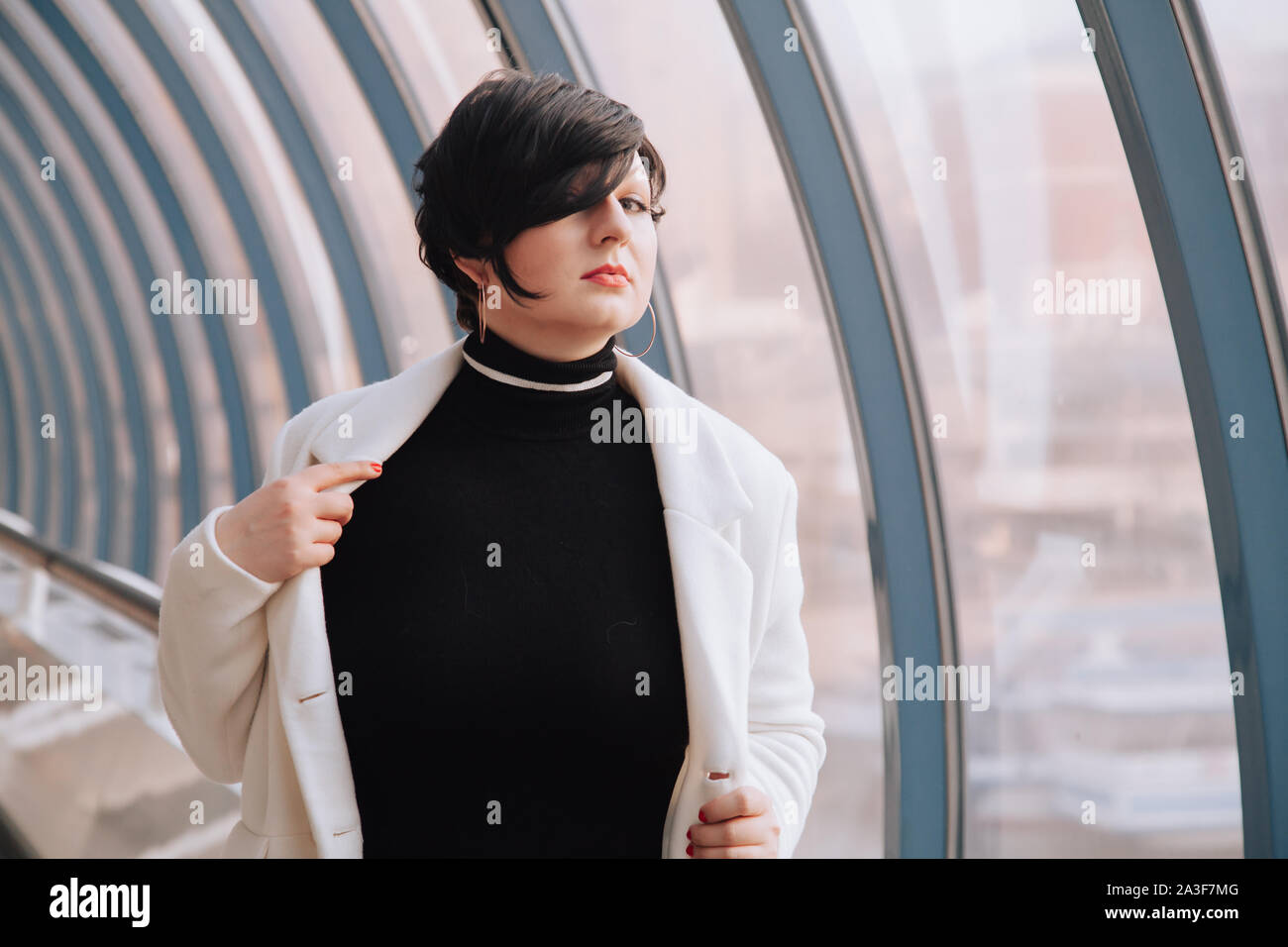 Young Beautiful Stylish Woman In White Wool Coat Walking Down The