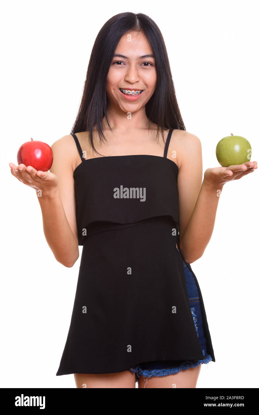Young happy Asian teenage girl smiling while holding red and gre Stock ...
