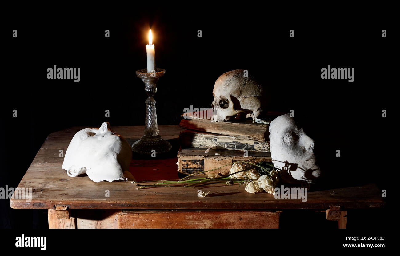 Classical Baroque Still-life in Vantias style with Skull and Death-Mask on a black Background Stock Photo