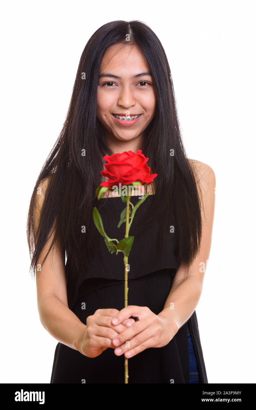 Young happy Asian teenage girl smiling while holding red rose Stock ...