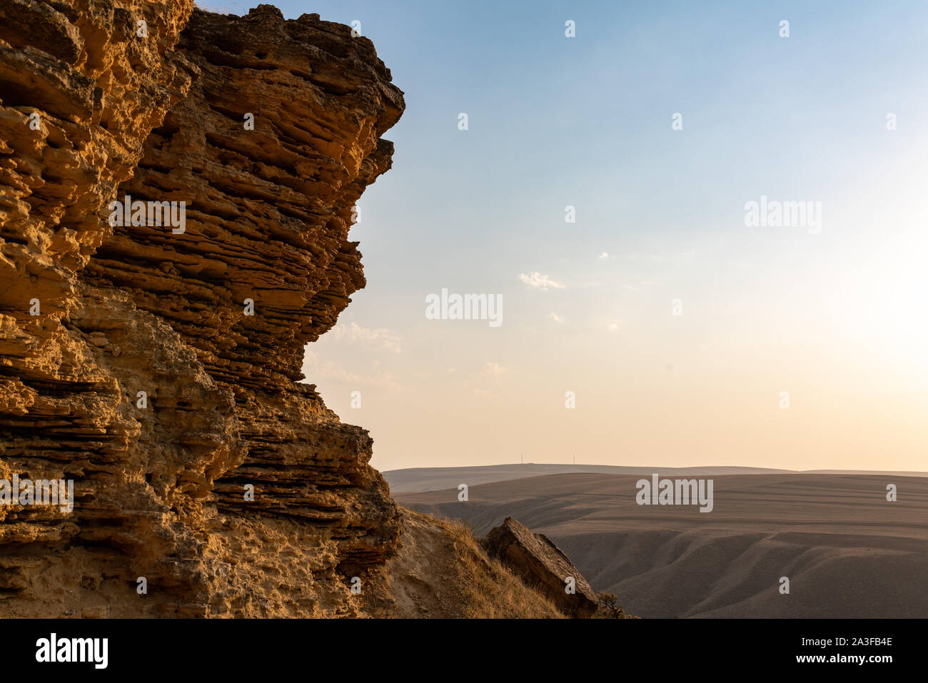 Cliff of sedimentary rocks against the blue sky Stock Photo