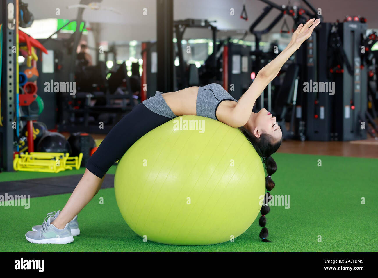 Fitness woman exercise with swiss ball in gym Stock Photo - Alamy