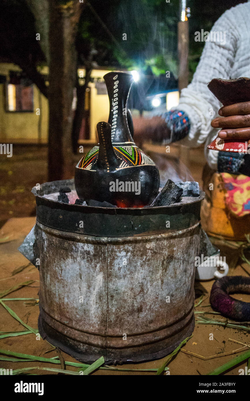 Coffee pouring during traditional coffee ceremony in Ethiopia, the birthplace of coffee. Stock Photo