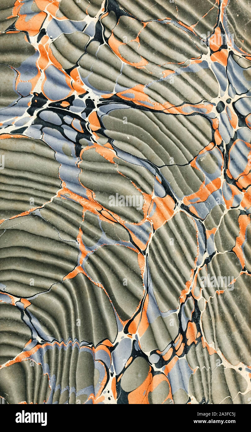 Hand marbled pastedown or endpaper from 19th century book binding featuring the Spanish moiré technique (Turkish pattern with a wave effect pattern beneath). Stock Photo