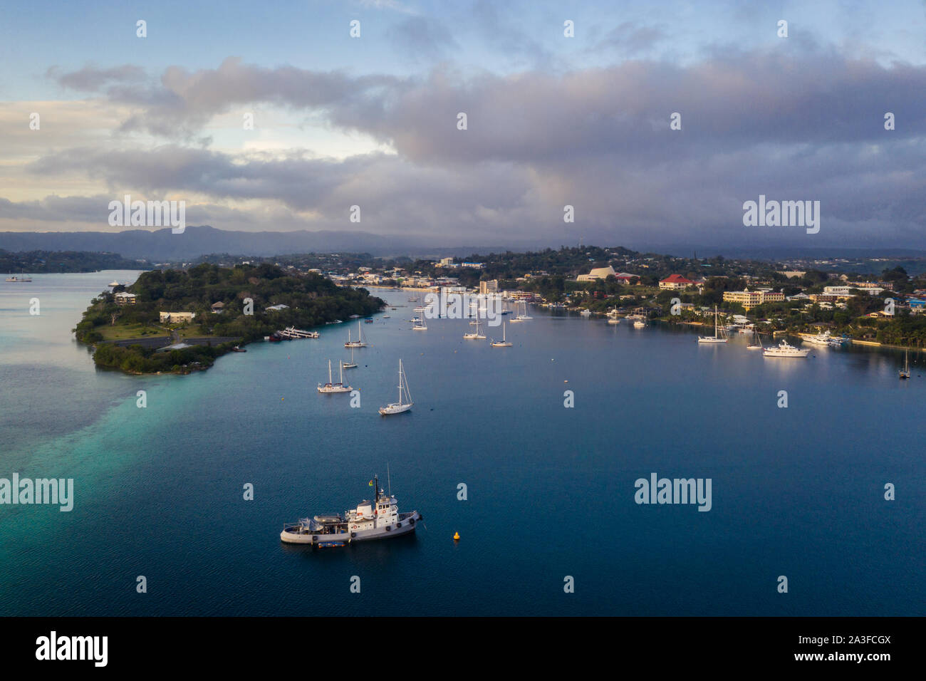 Nightfall over the Port Vila harbor with sailboat and other yachts in Vanuatu capital city of this south Pacific nation Stock Photo