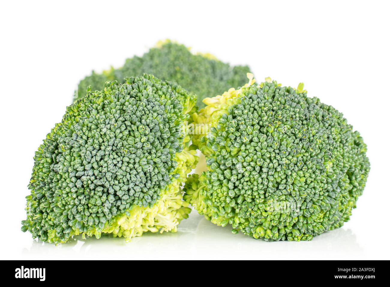 Three Broccoli Group of three whole fresh green broccoli isolated on white background ...