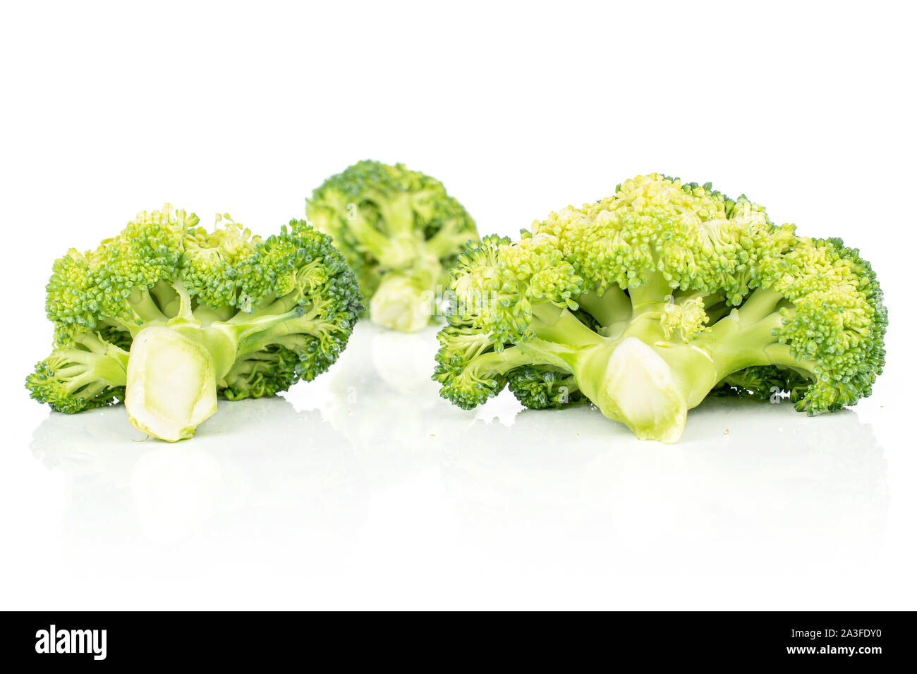 Three Broccoli Group of three whole arranged fresh green broccoli isolated on white ...