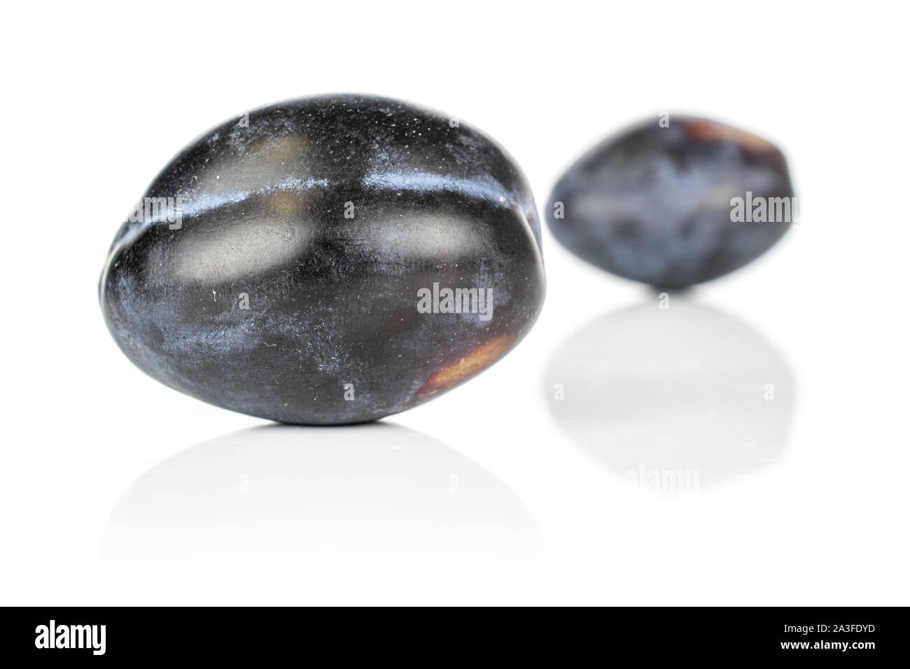 Group of two whole fresh purple plum isolated on white background Stock Photo