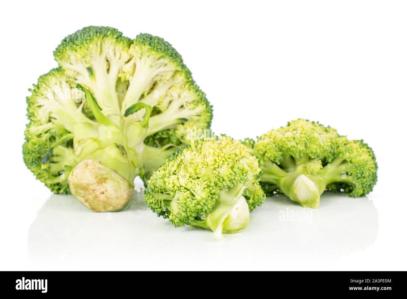 Group of three whole fresh green broccoli isolated on white background ...