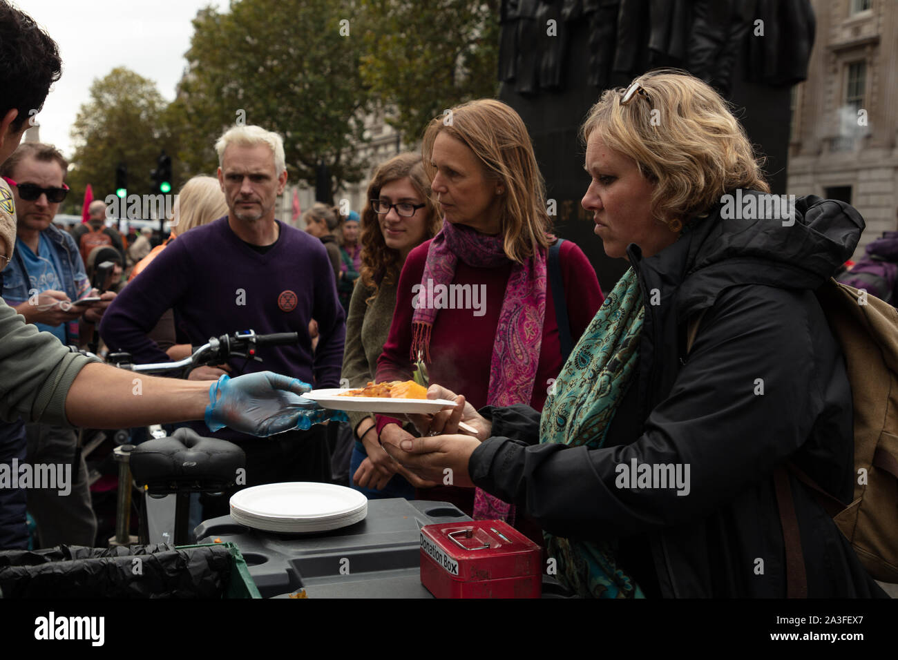 London, UK. 7th October 2019. Extinction Rebellion demonstrators at a food kitchen in Downing Street at a two week long protest in London. Credit: Joe Kuis / Alamy News Stock Photo