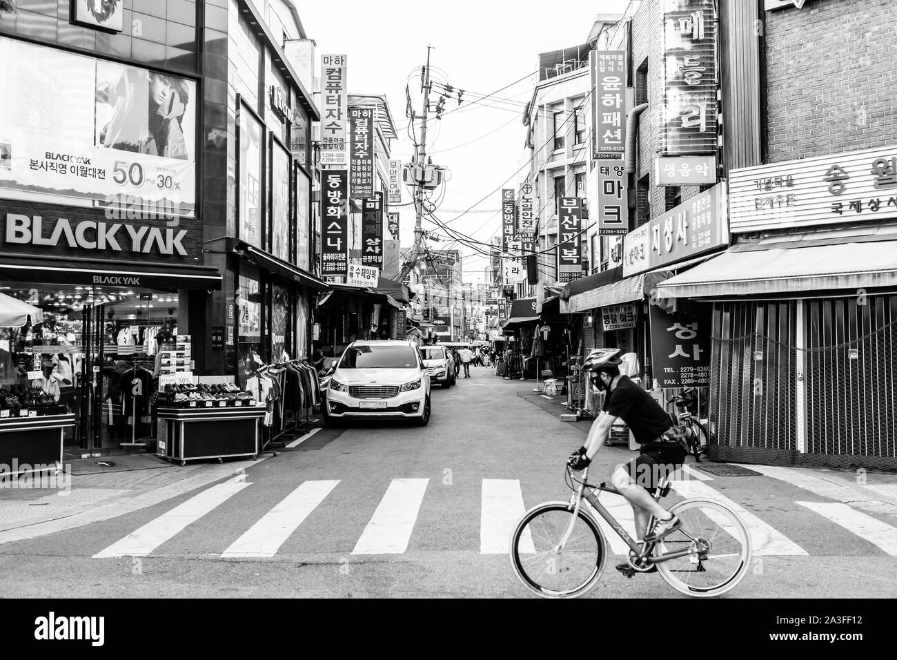 Seoul, South Korea - May 31, 2017: Cyclist crossing the street near Cheonggyecheon stream in Seoul. Stock Photo