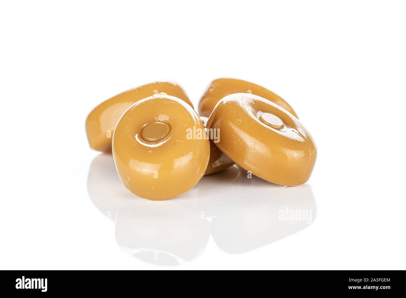 Group of four whole caramel brown candy isolated on white background ...