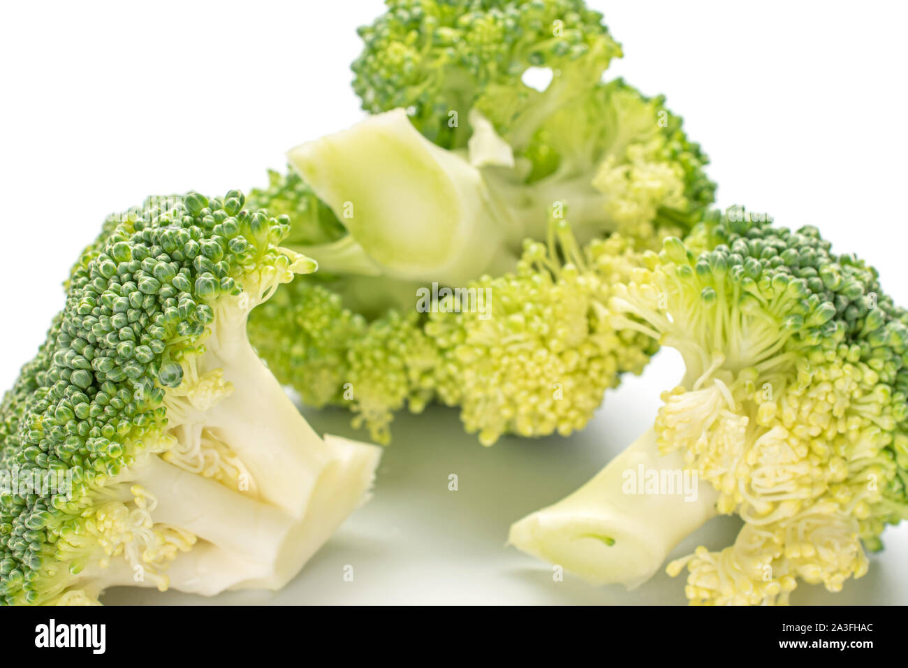 Three Broccoli Group of three whole fresh green broccoli closeup isolated on white ...