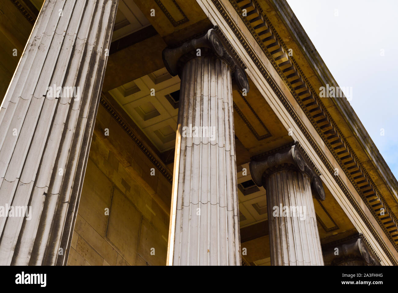 Columns on the exterior of a historic building with detailed stone work Stock Photo