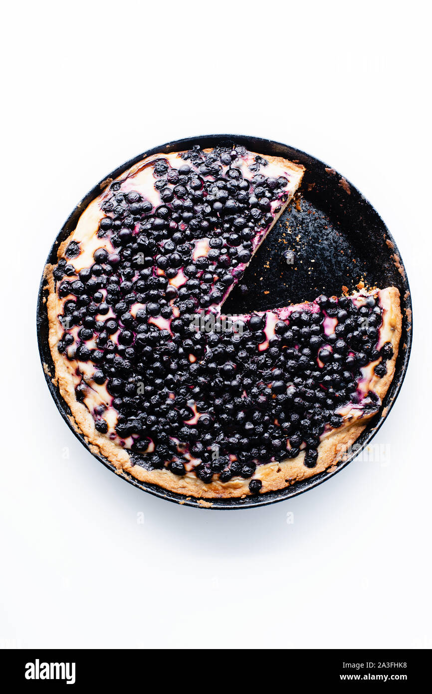 Summer tart with fresh blueberries, one wedge cut Stock Photo
