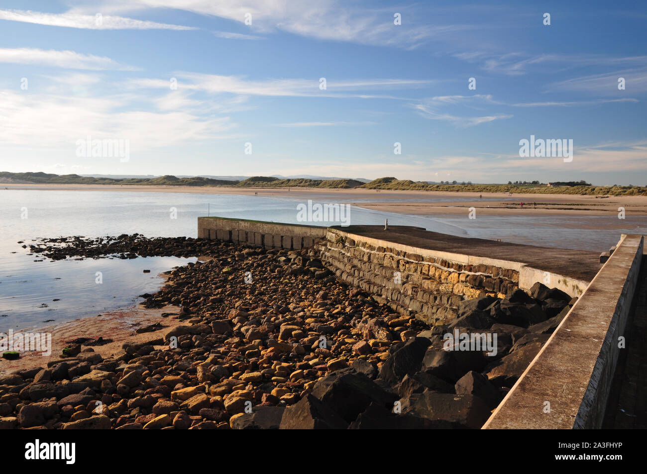 Beadnell bay and harbour wall, Northumberland Stock Photo