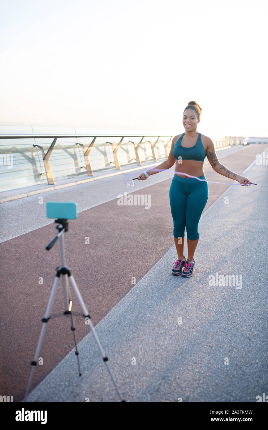 Sports blogger skipping the rope and making video Stock Photo