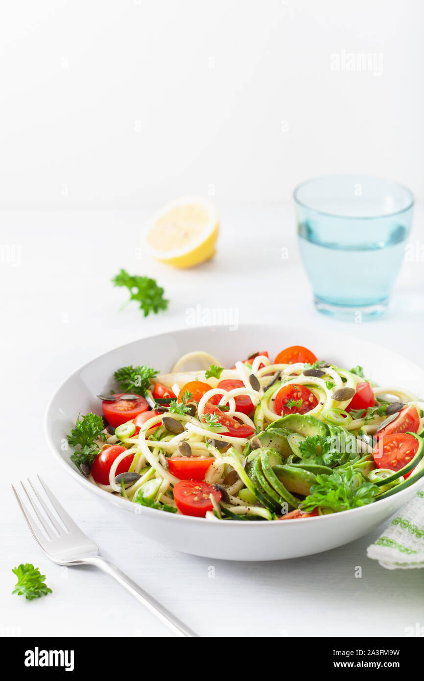 vegan ketogenic spiralized courgette salad with avocado tomato pumpkin seeds Stock Photo