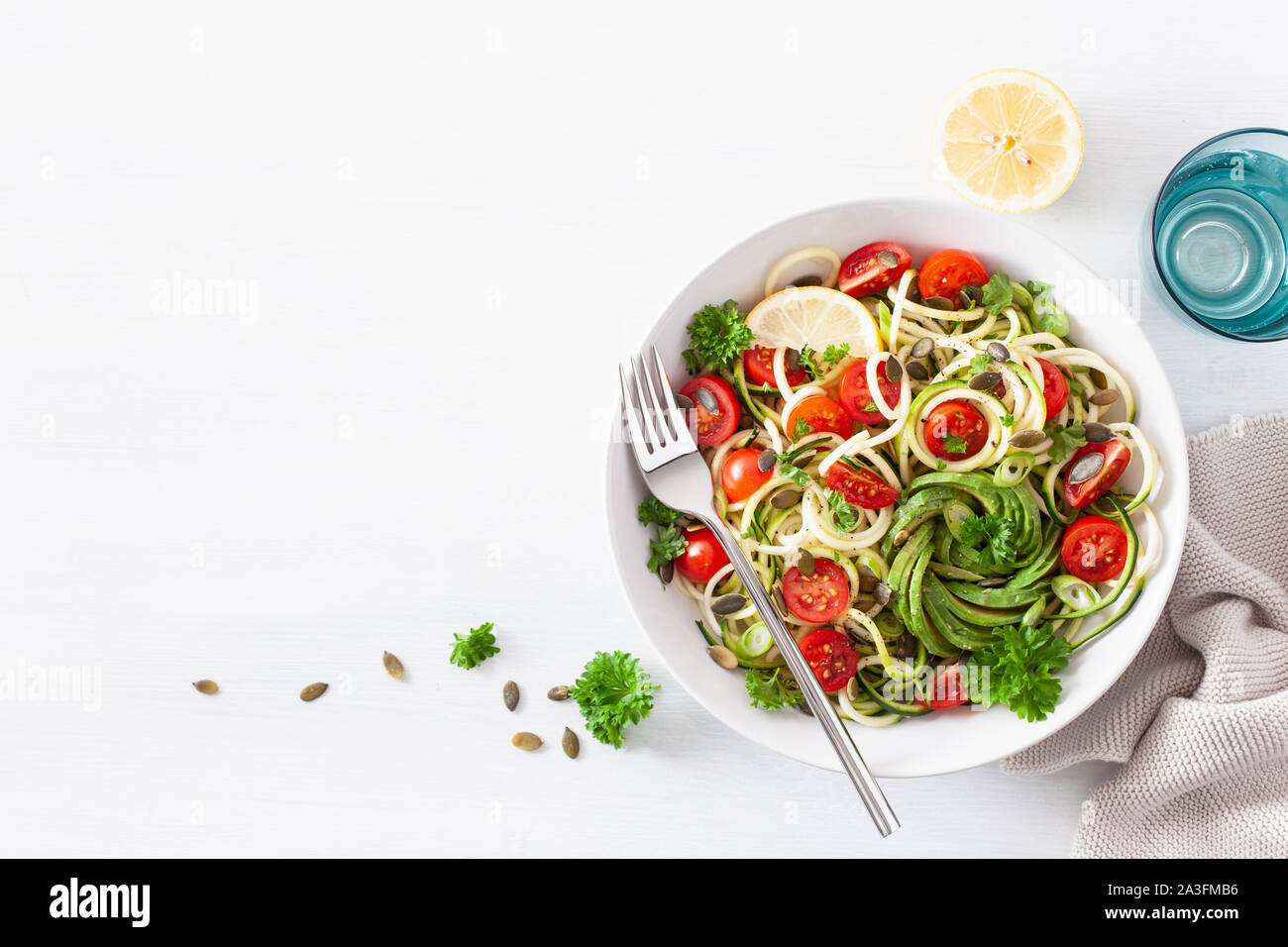 vegan ketogenic spiralized courgette salad with avocado tomato pumpkin seeds Stock Photo