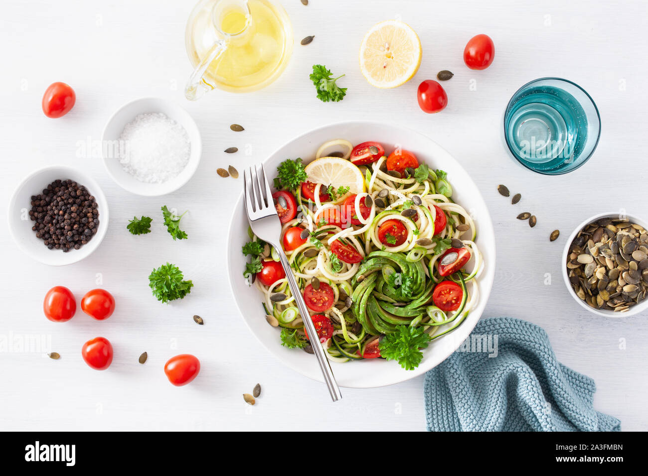 vegan ketogenic spiralized courgette salad with avocado tomato pumpkin seeds Stock Photo