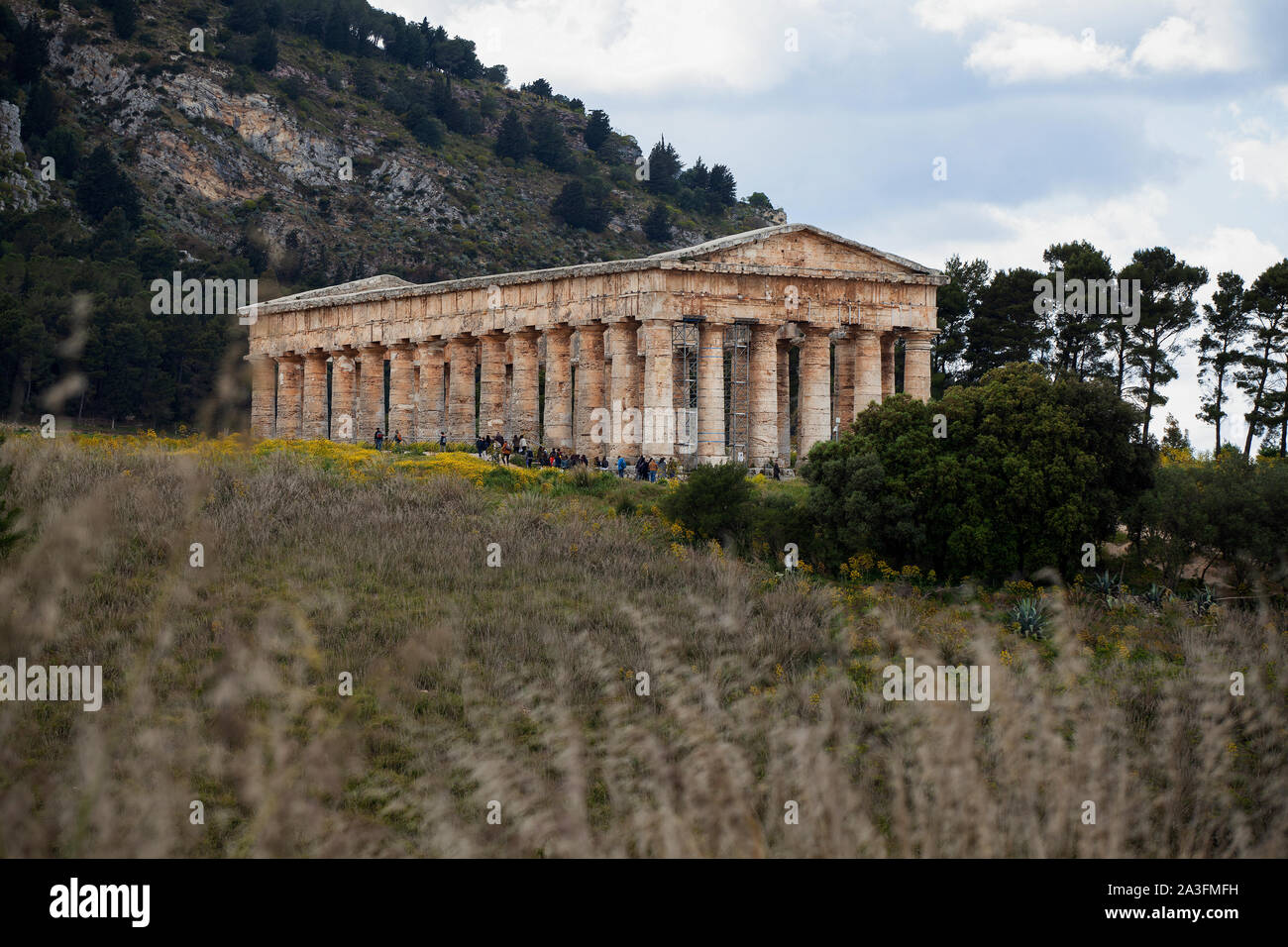 A view across the Sicilian landscape towards the ancient temple at Segesta, build in a Classical Greek style in the early fourth century BC. Stock Photo