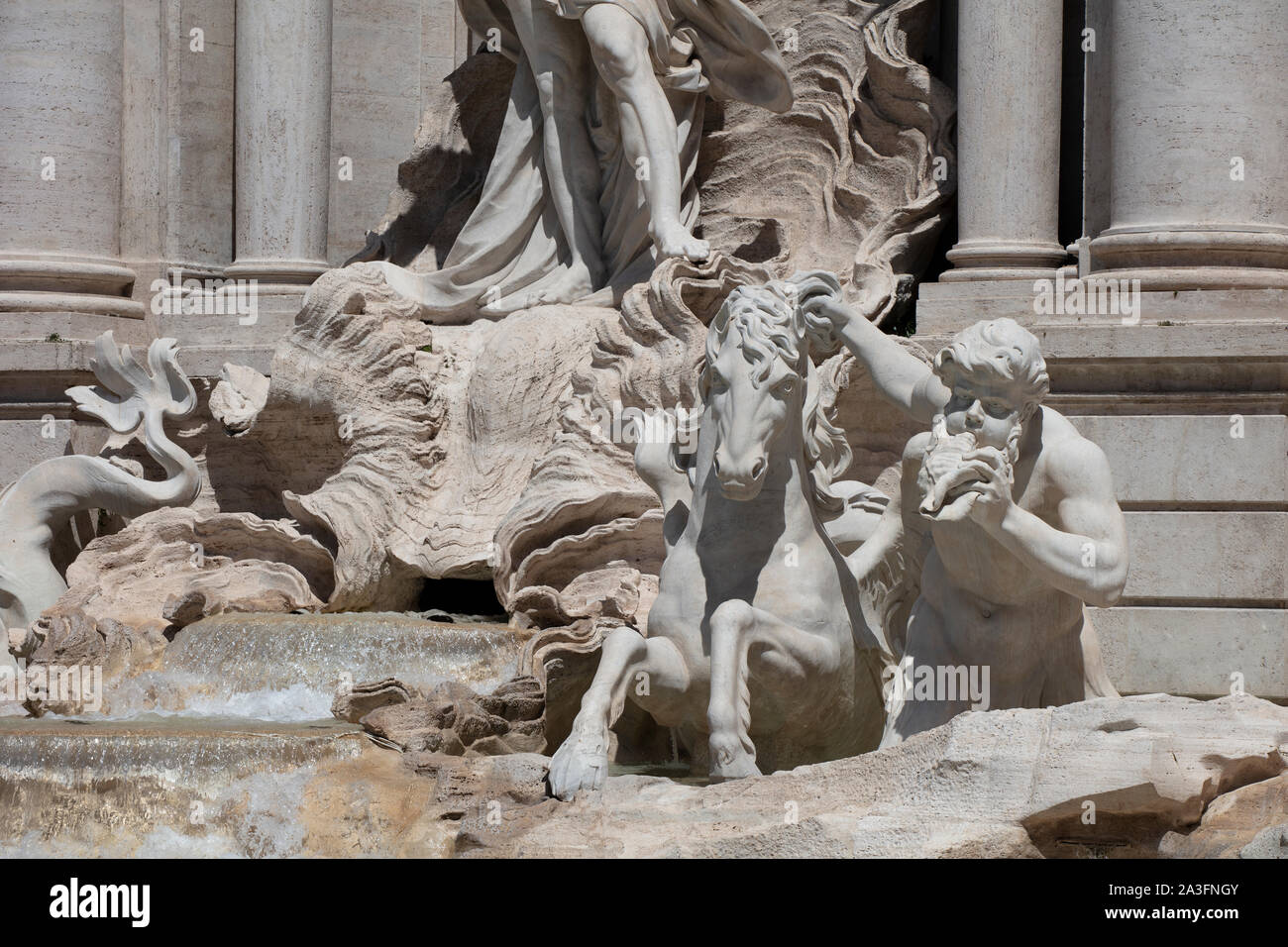 Detail of the statues on the Trevi Fountain in Rome, showing the tritons and sea horses struggling on the rocks. Stock Photo