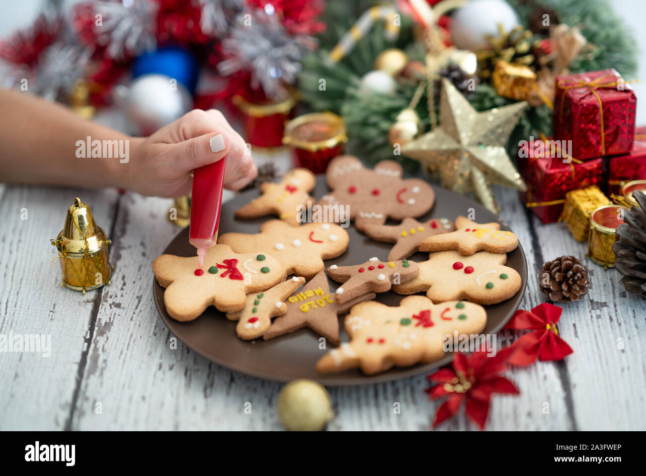 Preparing traditional gingerbread cookies with ornaments for new year celebration. Stock Photo