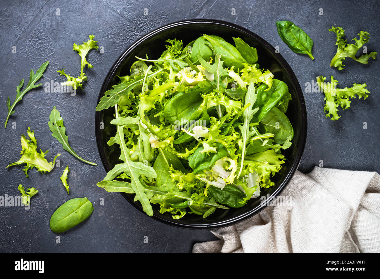 Green salad leaves mix on black top view Stock Photo Alamy