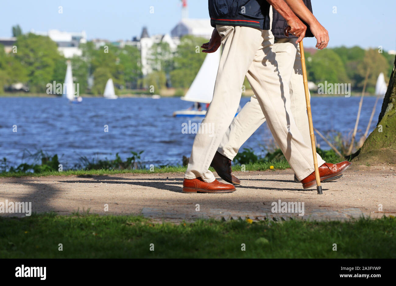 getleman with walking cane at alster lake in Hamburg Stock Photo